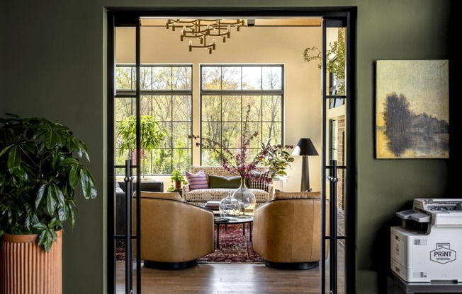 a living room with two couches and a table and a large window