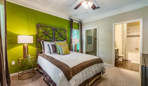 a bedroom with green walls and a white bed at Echo at Lake Norman, North Carolina