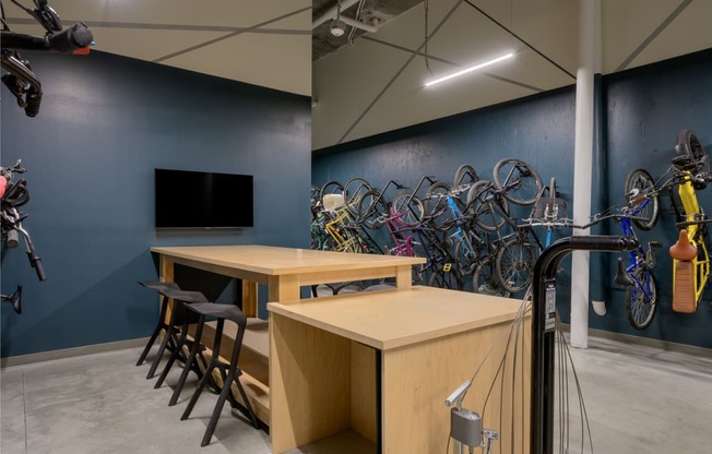 a room with tables and chairs and bicycles on the wall at The Lucy Boise Apartments, Idaho