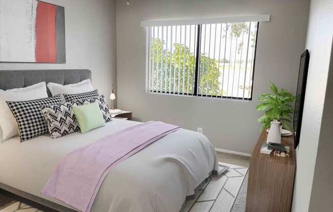 a bedroom with gray walls and a large window