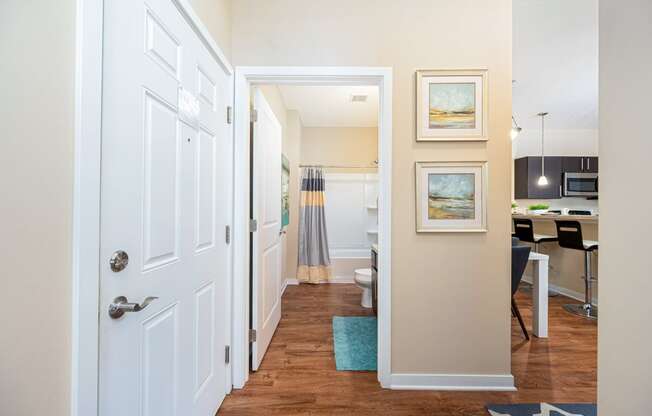 a hallway with a door to a kitchen and a living room