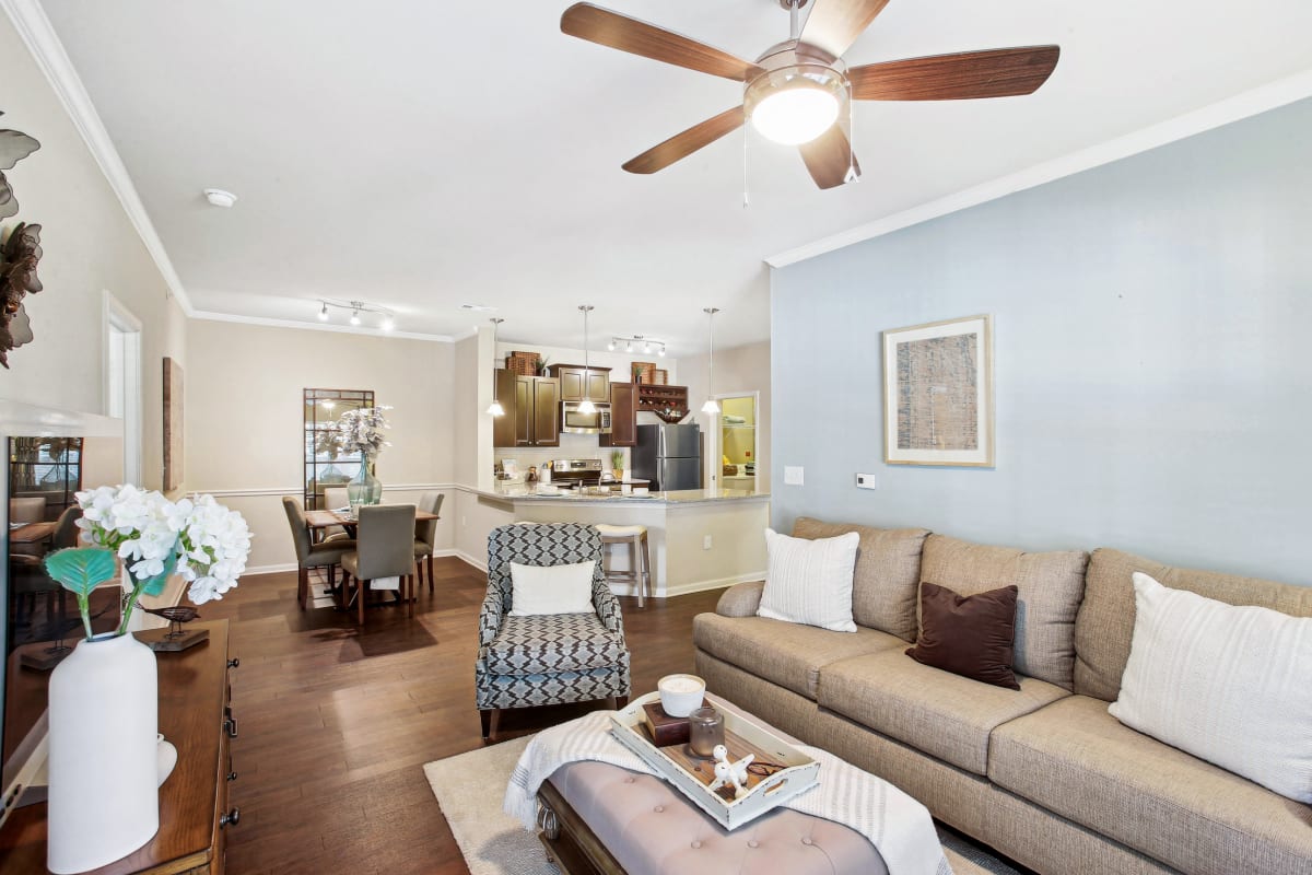 a living room with a couch and a ceiling fan