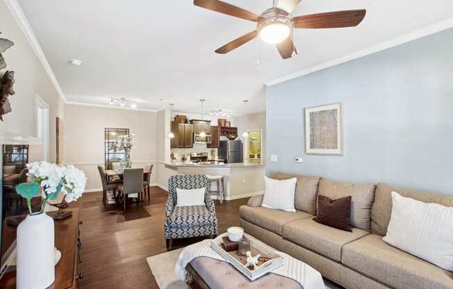 a living room with a couch and a ceiling fan