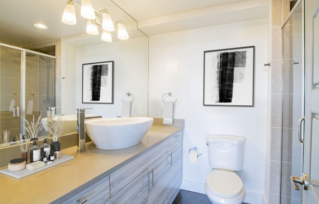 a bathroom with a sink and a toilet and a shower