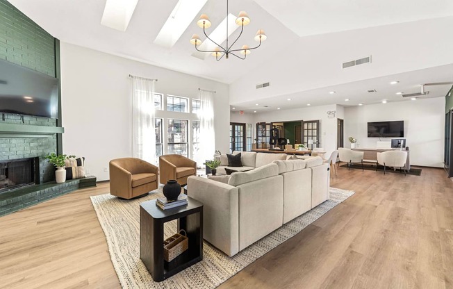 A modern living room with a fireplace and a large couch.