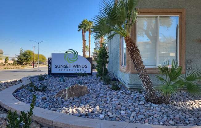 the sign outside of sunset winds guest house