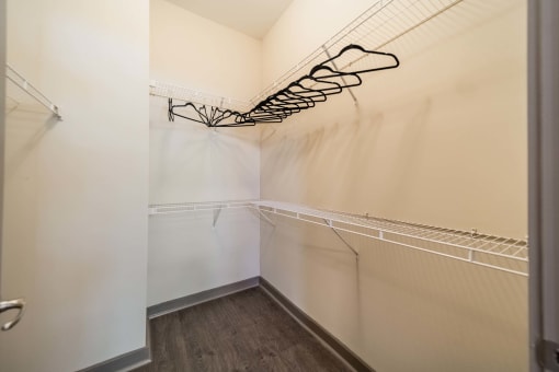 a closet in a bedroom with a shoe rack on the wall