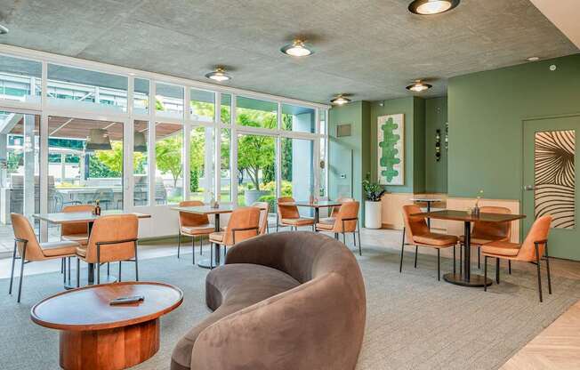 A room with a green wall and a table with chairs.