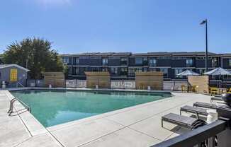 a swimming pool with a building in the background at Highland Mill Lofts, Charlotte, NC