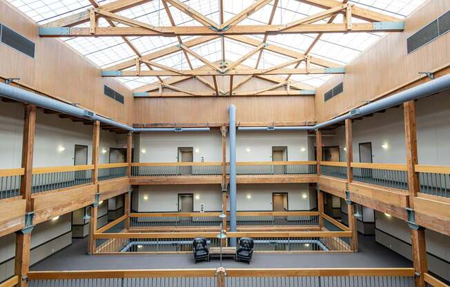 the inside of a large building with a large skylight and a balcony at Lowertown Commons Apartments, St. Paul, MN, 55101