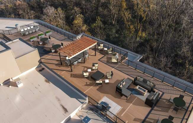 A rooftop patio with a table and chairs.