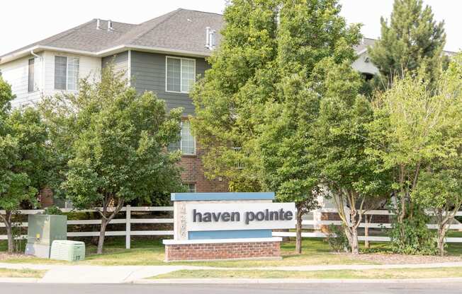 a sign for haven pointe in front of a house