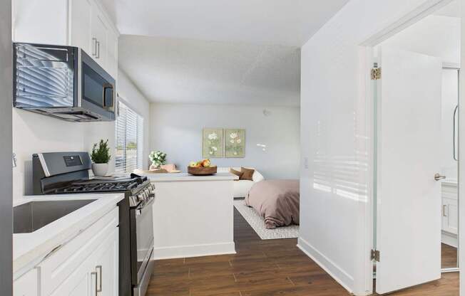 A kitchen with white cabinets and a black stove top oven.