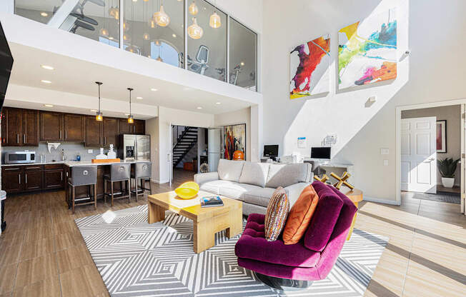 A modern living room with a purple armchair and a wooden coffee table.