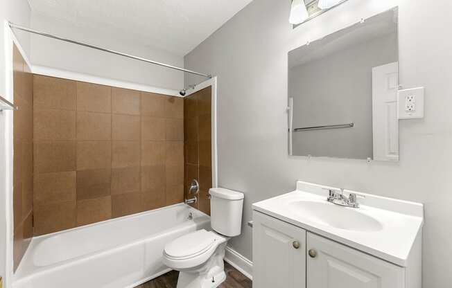 a bathroom with a sink toilet and a tub