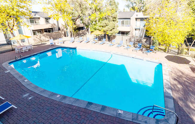a swimming pool with chairs