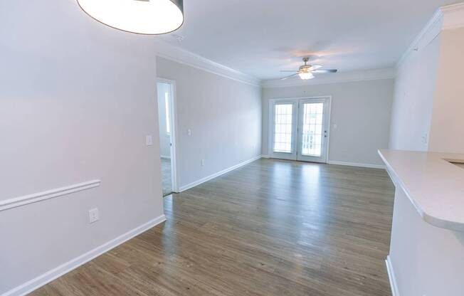 A room with a wooden floor and a ceiling fan.