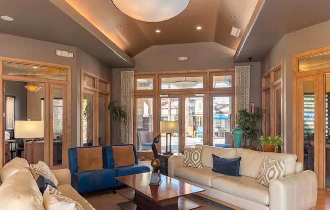 a living room filled with furniture and a large window