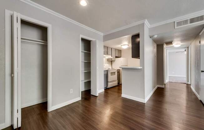 A kitchen area with a refrigerator, sink, and cabinets.