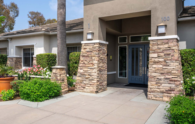 the front of a house with a walkway and a blue door