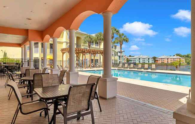 Pool and pergola with covered patio at Bermuda Estates Apartments in Ormond Beach, FL