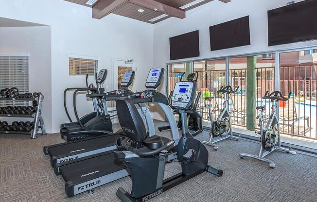 Treadmills, stationary bikes, and free weight inside a state of the art fitness center