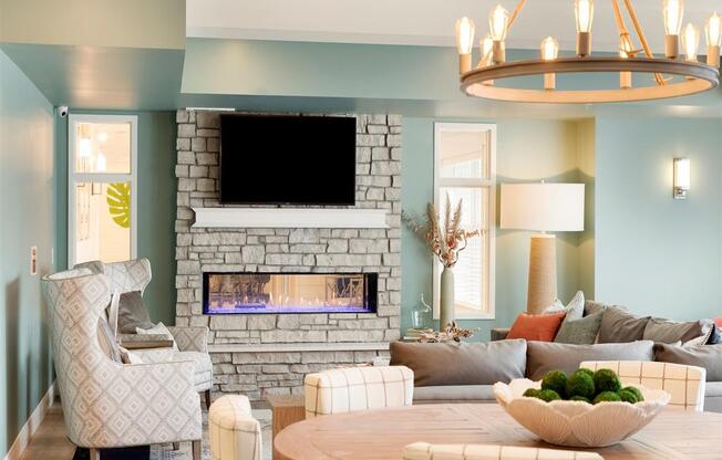 Clubroom with fireplace, large TV and seating