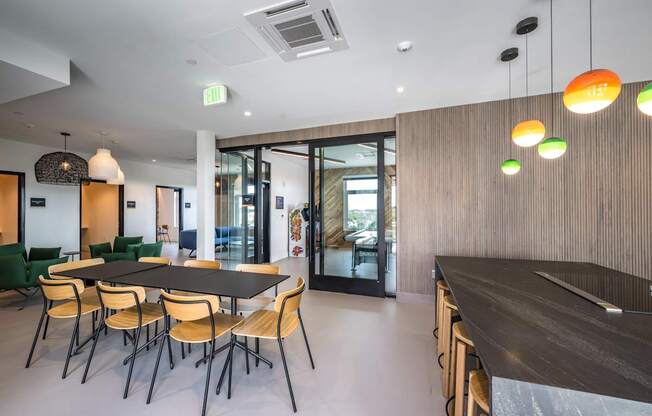 A modern dining room with a long table and chairs.