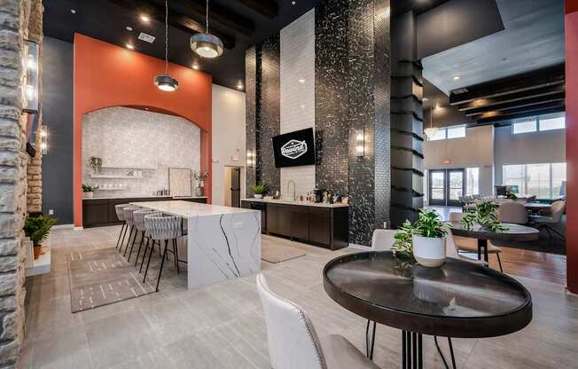 A modern dining area with a black table and white chairs.