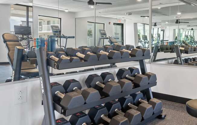 a gym with rows of dumbbells on a rack at The Teale Navy Yard, North Charleston, SC, 29405