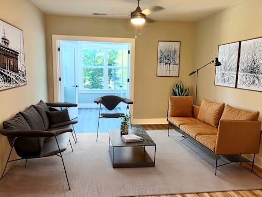 a living room with a couch and a chair and a table