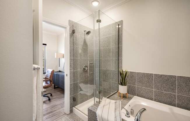 a bathroom with a shower and a tub at Arlo Luxury homes Apartments, Little Rock, 72210