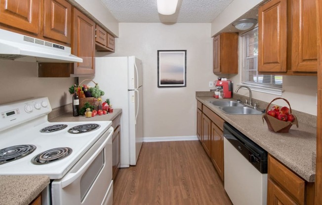 a kitchen with white appliances and wooden cabinets