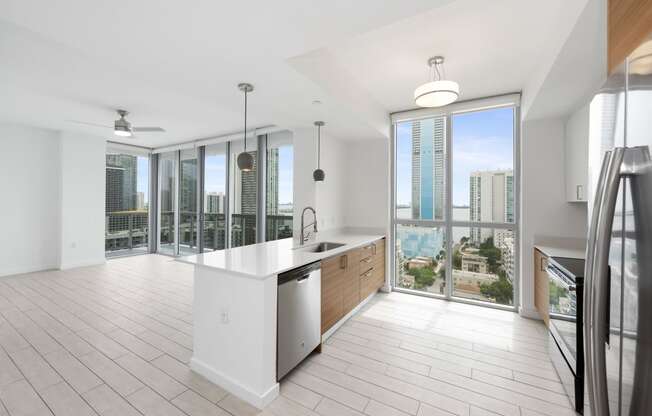 a kitchen and living room with a view of the city