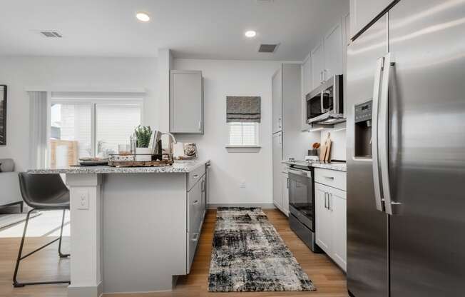 a kitchen with stainless steel appliances and a counter top