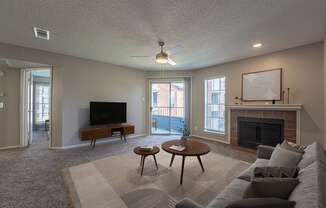 A living room with a fireplace and a television.