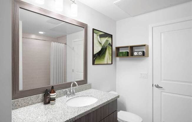 A bathroom with a white toilet and a sink.