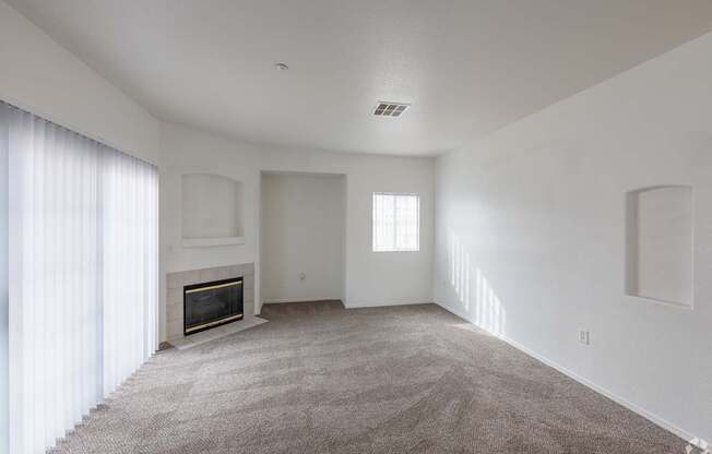 A living room with a fireplace and carpeted floor.
