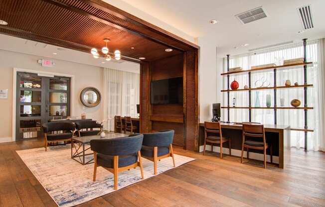 A living room with a dark blue sofa and wooden floors.