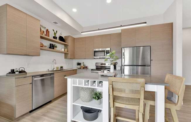 A modern kitchen with wooden cabinets and stainless steel appliances.