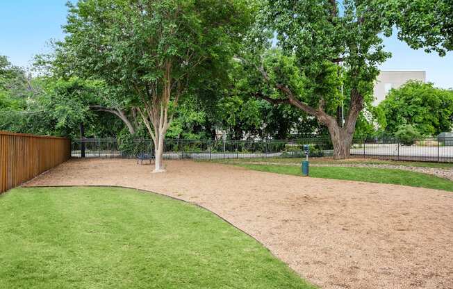 A park with a green lawn and trees.