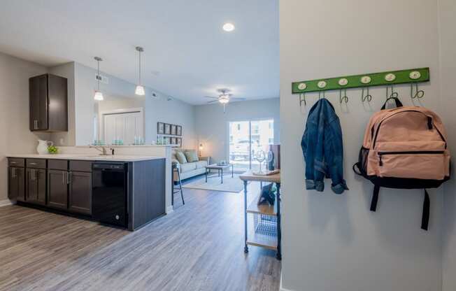 a kitchen and living room with a backpack on the wall