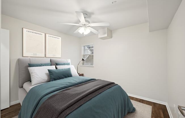 a bedroom with a bed and a ceiling fan at Woodlands of Plano