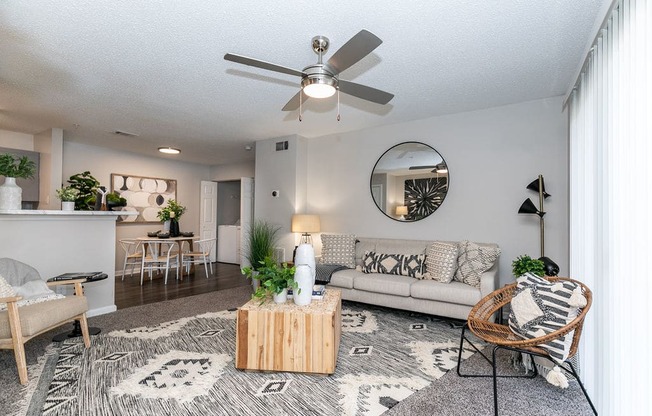 a living room with a couch and a ceiling fan