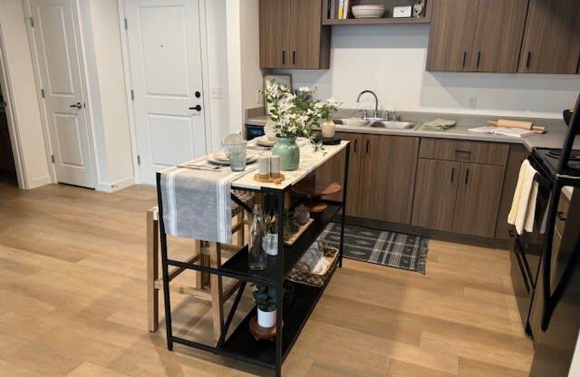 a kitchen with a table in the middle of it