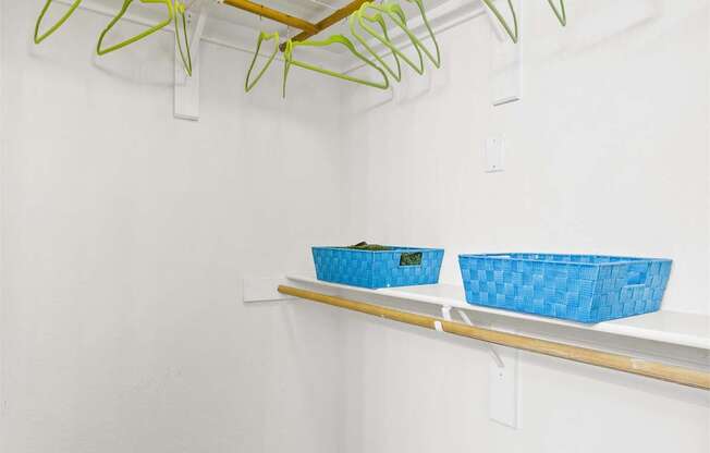 a laundry room with shelves and baskets on the wall