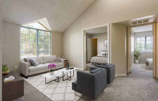 a living room with couches and chairs and a rug