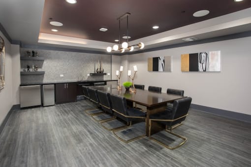 a conference room with a long table and chairs and a kitchen