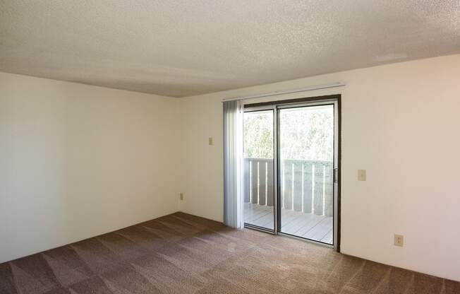 Rolling Hills Vacant Apartment Living Room & Sliding Door to Deck