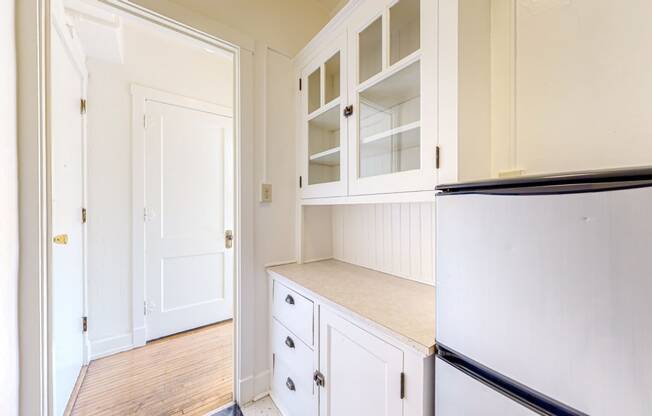 A Gorgeous Retro Kitchen with White Cabinetry and Restored Hardwood Flooring at The Park Apartments in Minneapolis, 55403